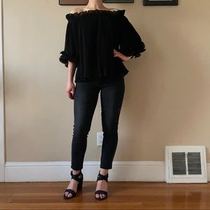 Black flowy off-the-shoulder top with ruffles